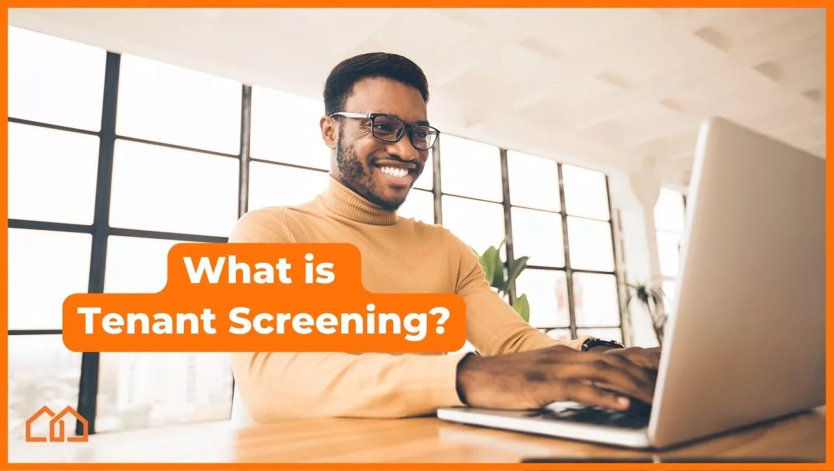 picture of a man on a computer next to the text "what is tenant screening?"