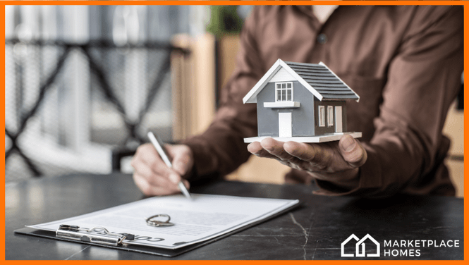 picture of a hand holding a model home.