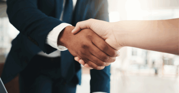 Landlord shaking hands with a Marketplace Homes property manager in Detroit.